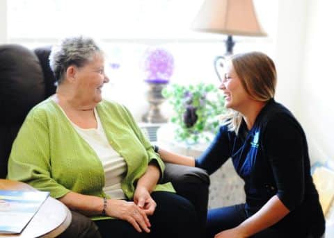 Home health care aide proving personal care to patient